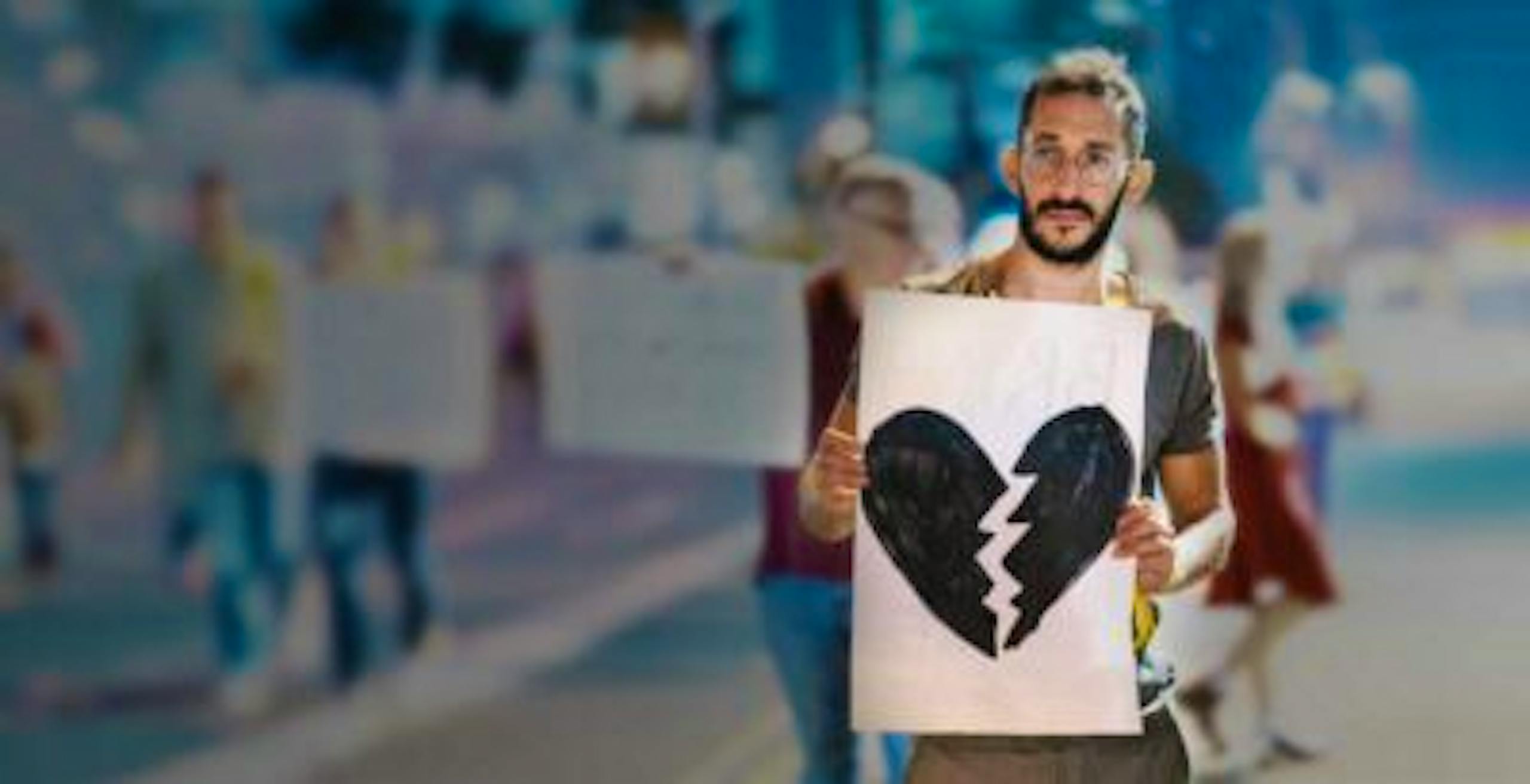 Jewish man holding sign on street