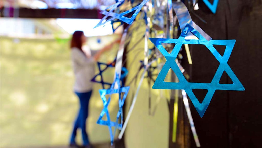 Woman decorating a sukkah