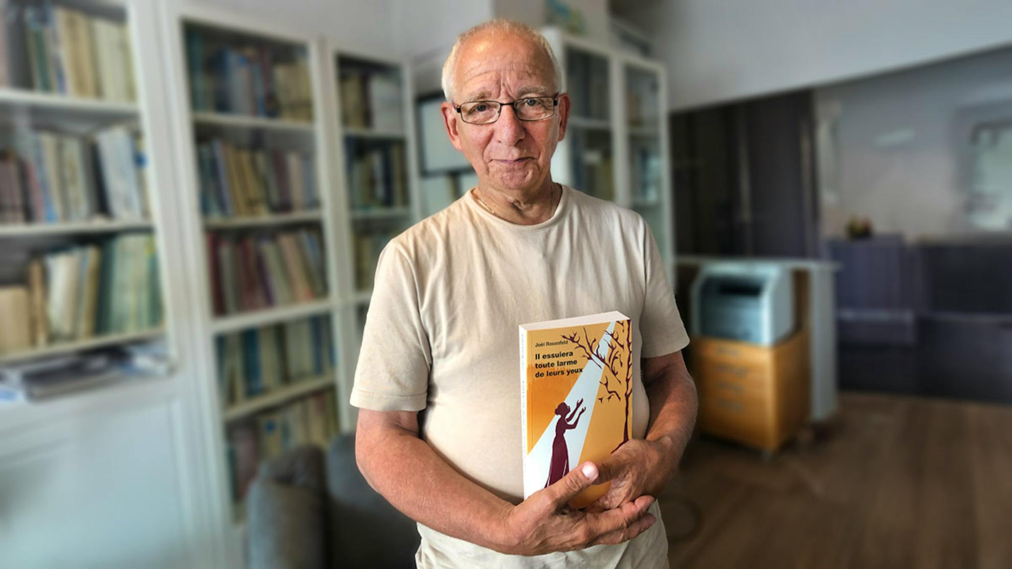 Joël holding a book he authored