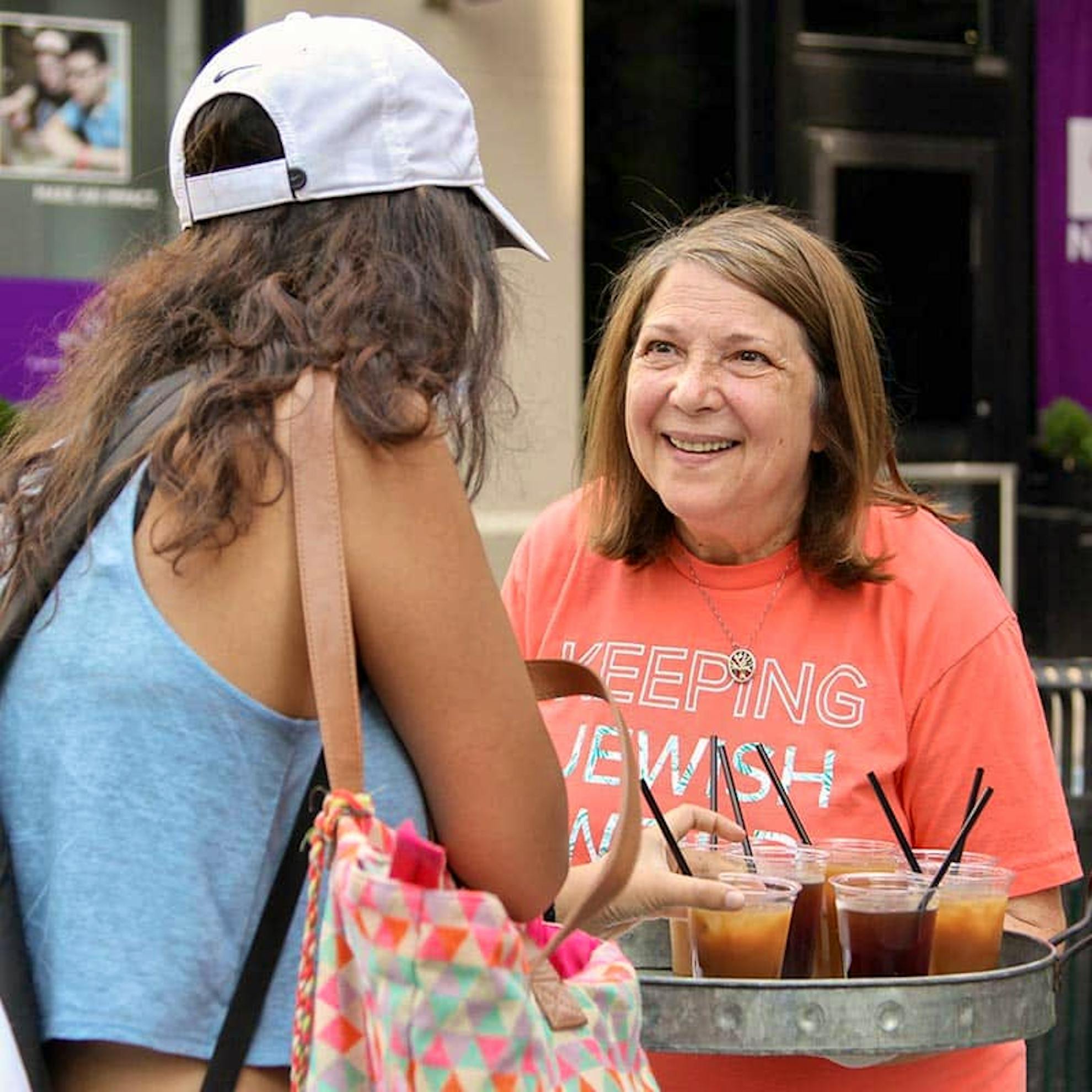 Susan Perlman talking with a young woman in NY