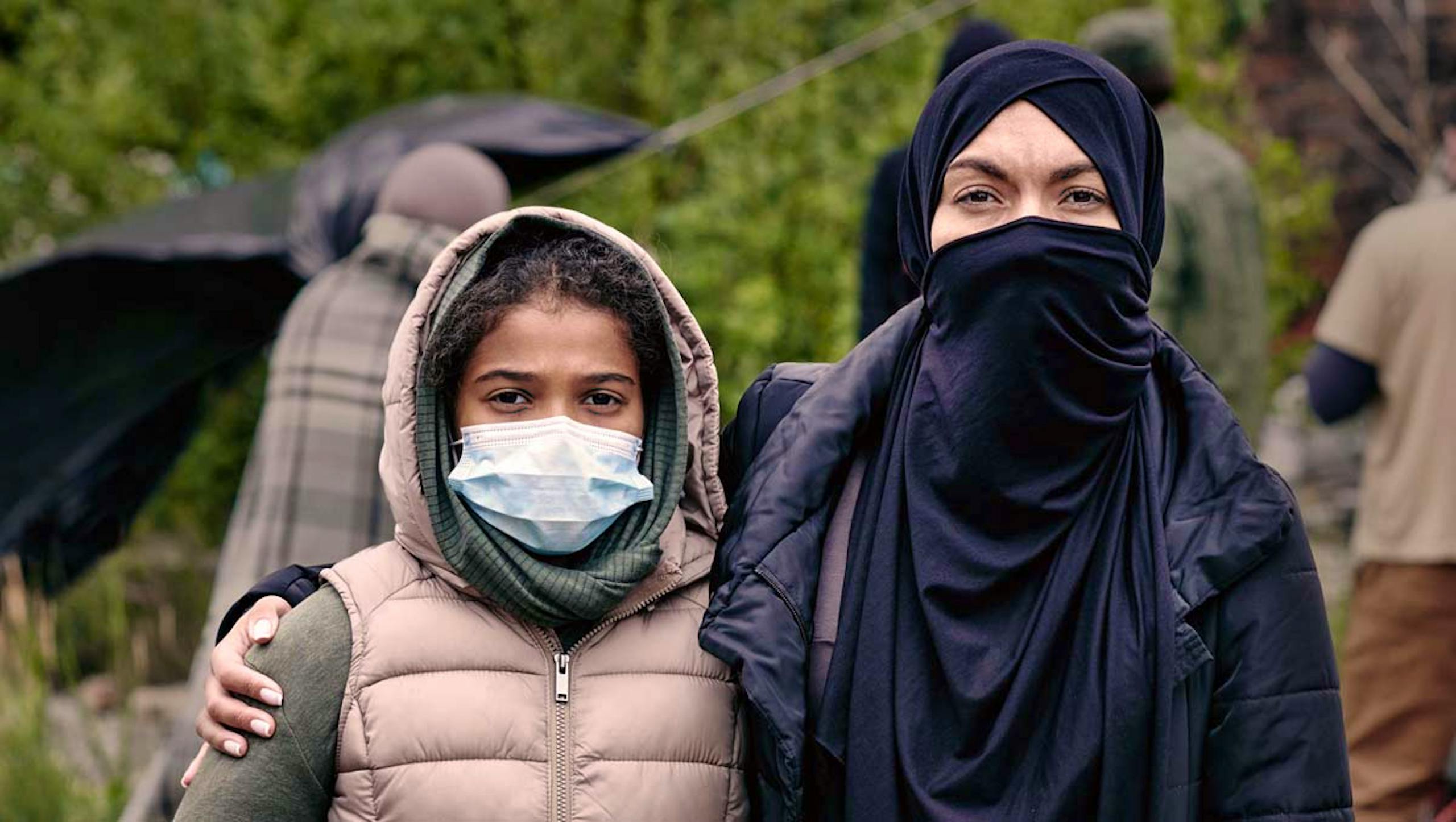 a couple wearing masks