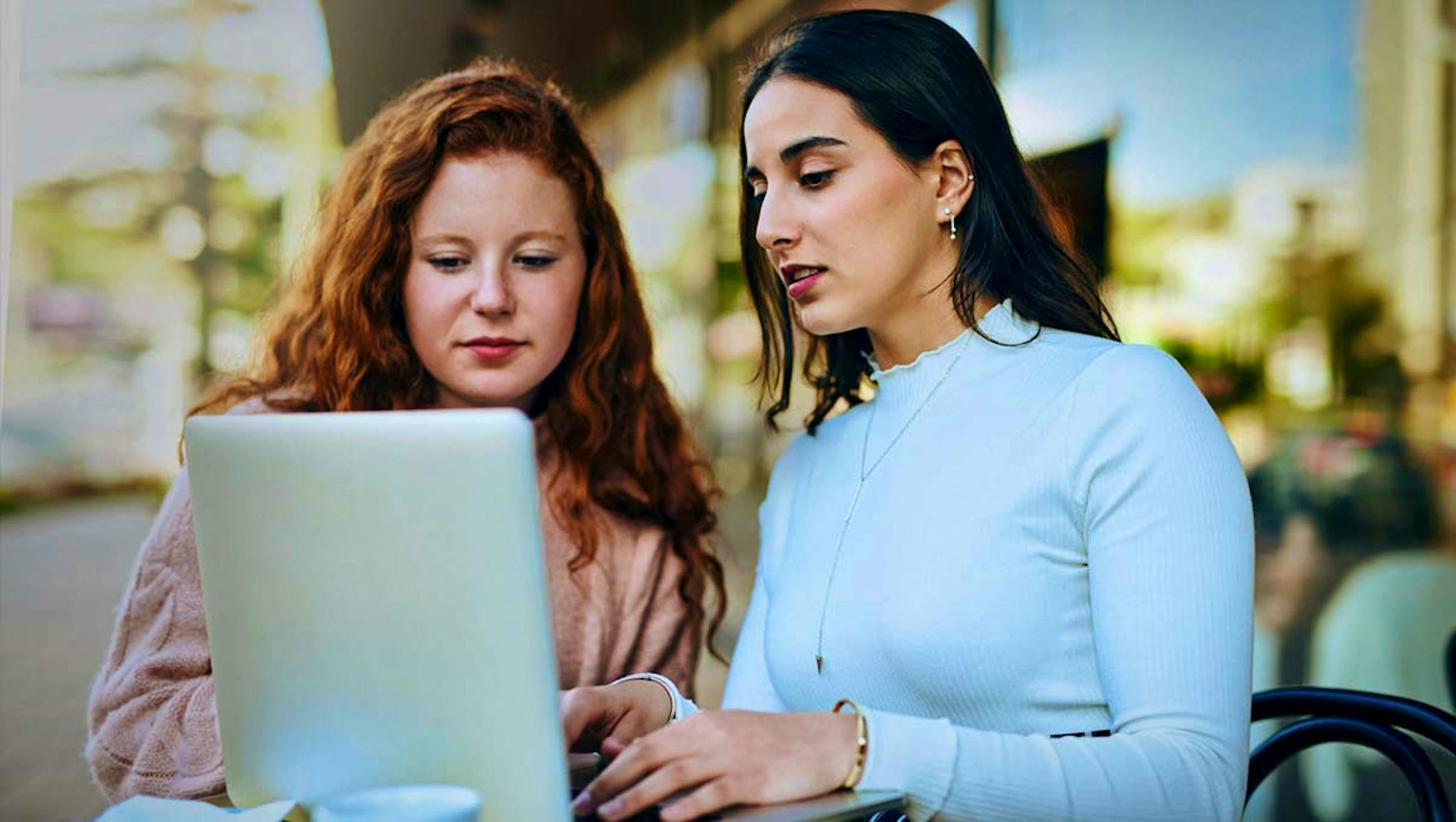 two ladies looking at computer