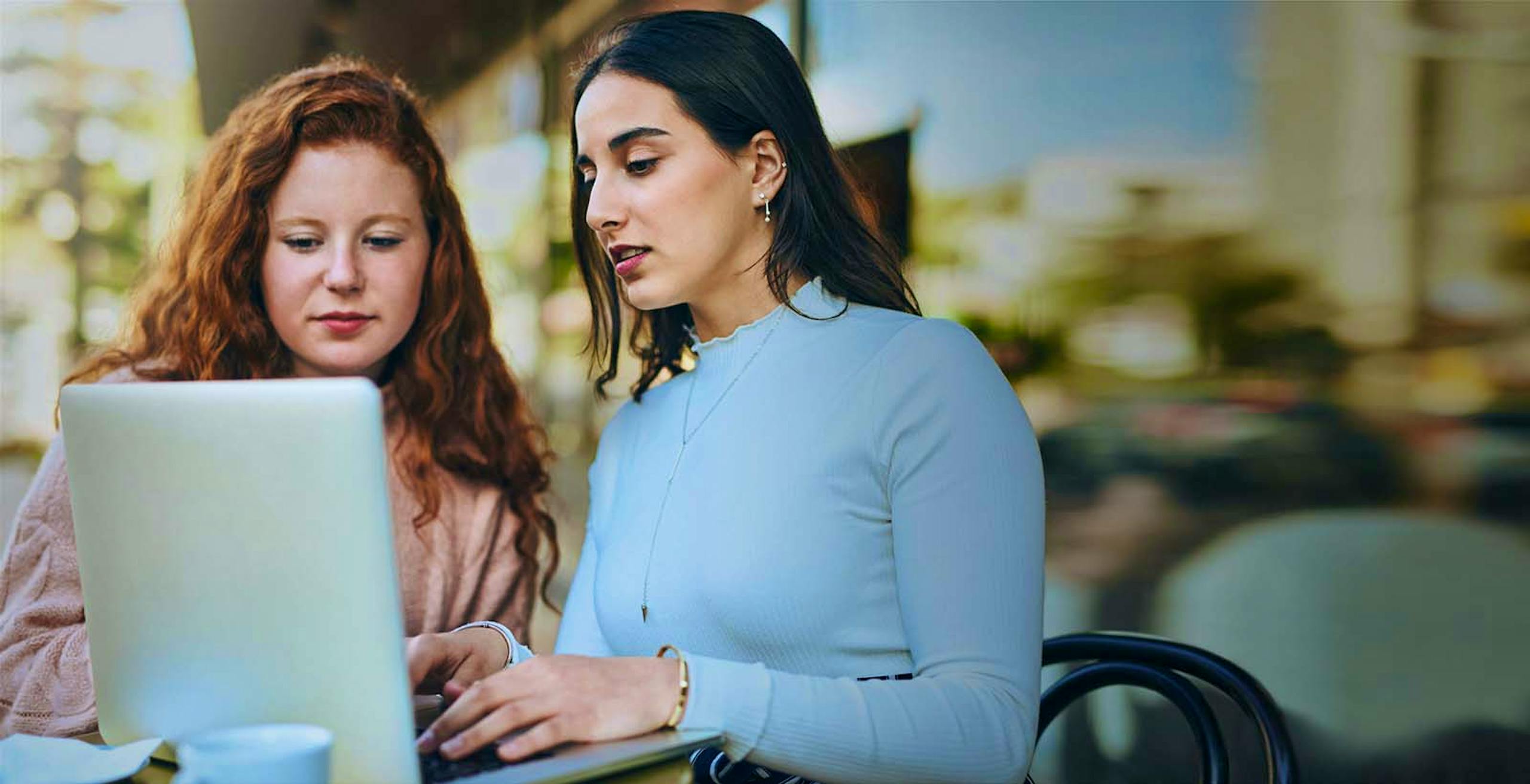 two ladies looking at computer